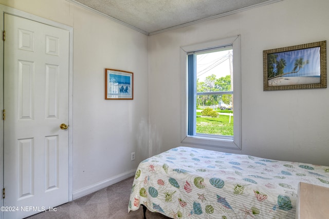 carpeted bedroom featuring a textured ceiling