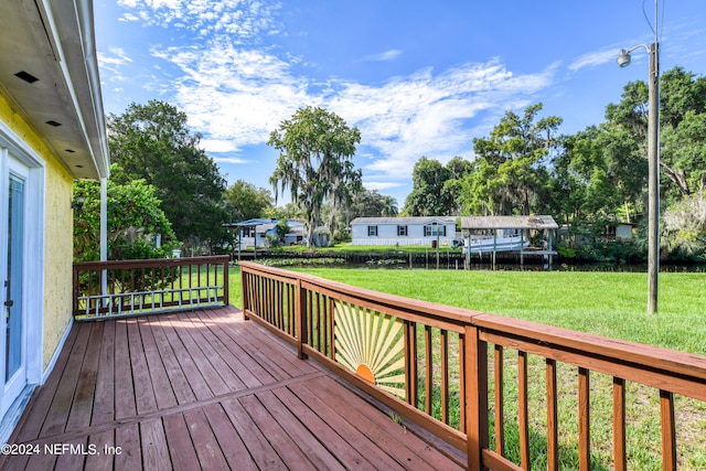 wooden terrace with a lawn