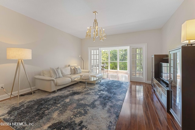 living room featuring a notable chandelier and dark hardwood / wood-style flooring