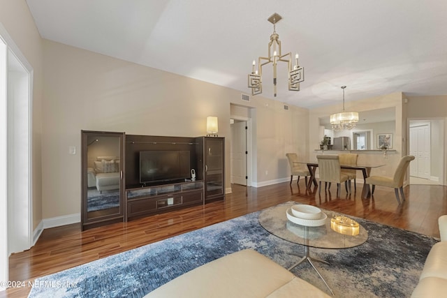 living room with hardwood / wood-style flooring and an inviting chandelier