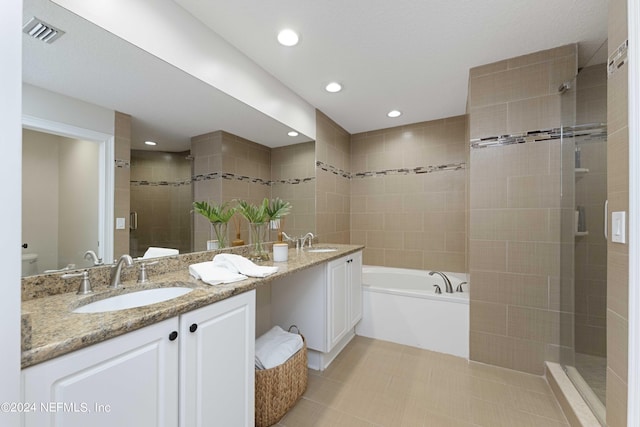 full bathroom with tile patterned flooring, vanity, toilet, and independent shower and bath