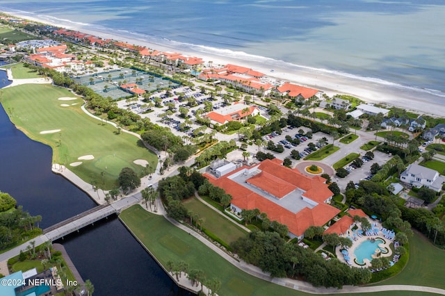 drone / aerial view featuring a water view and a beach view