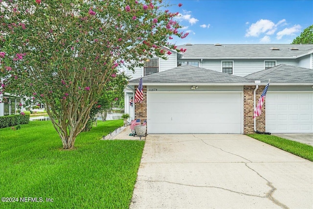 front facade with a garage and a front yard