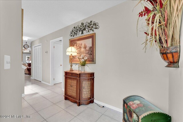 corridor featuring light tile patterned floors