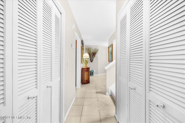 hall featuring light tile patterned floors