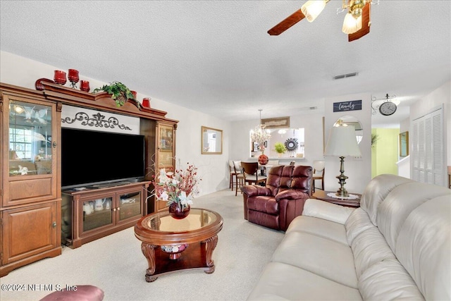 carpeted living room featuring ceiling fan and a textured ceiling