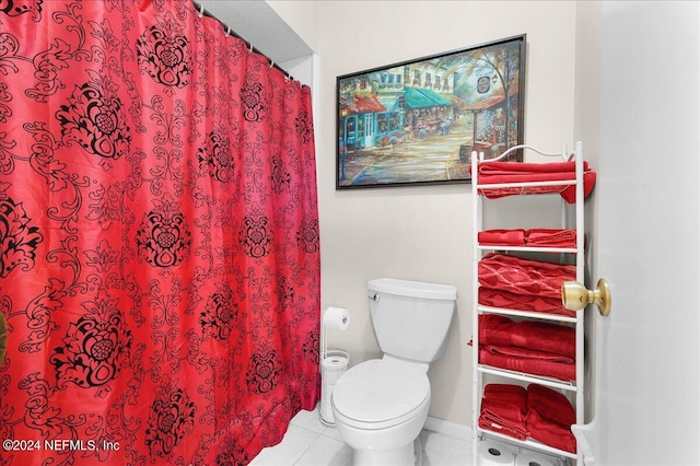 bathroom with toilet and tile patterned floors