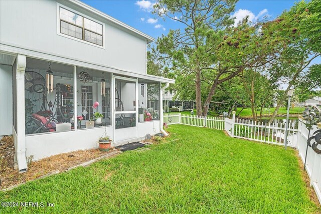 view of yard featuring a sunroom