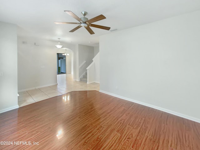 tiled empty room with ceiling fan