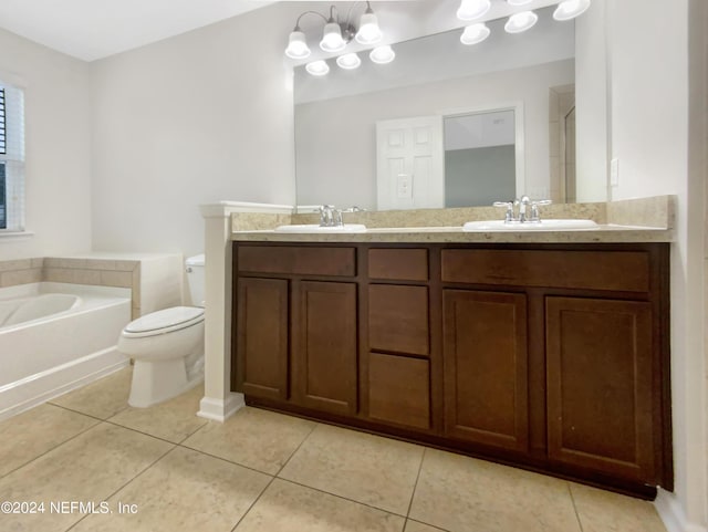 bathroom with vanity, a bath, tile patterned flooring, a chandelier, and toilet