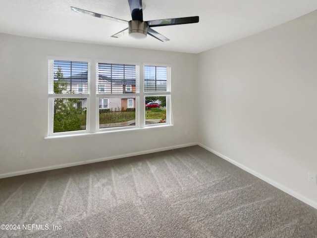 spare room featuring carpet flooring, ceiling fan, and a healthy amount of sunlight