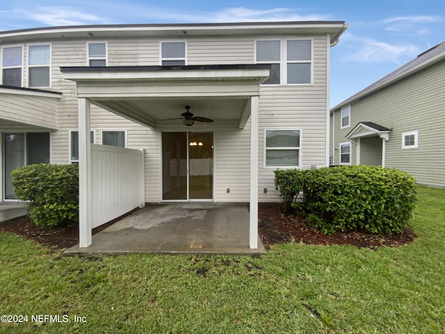 property entrance with a yard, ceiling fan, and a patio area