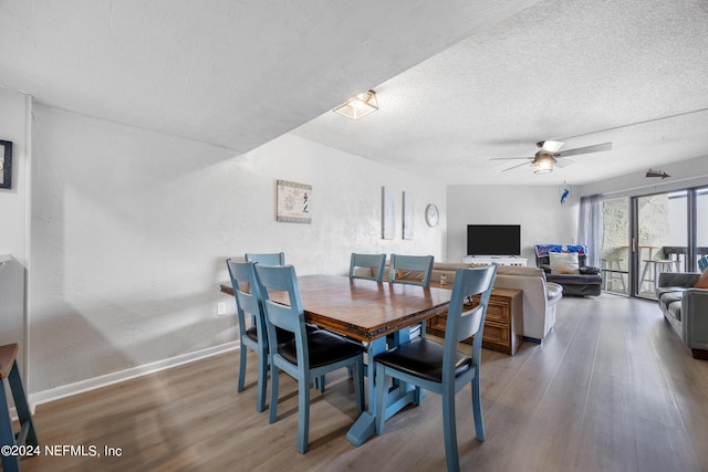 dining space featuring a textured ceiling, ceiling fan, and dark hardwood / wood-style floors