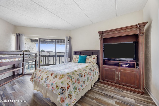 bedroom featuring access to exterior and hardwood / wood-style flooring