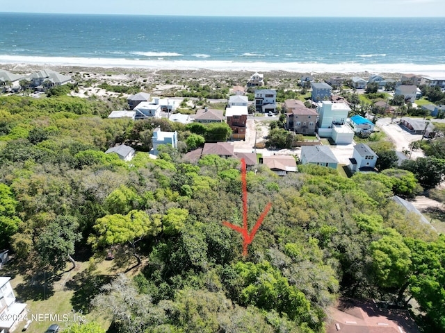 bird's eye view featuring a water view and a view of the beach