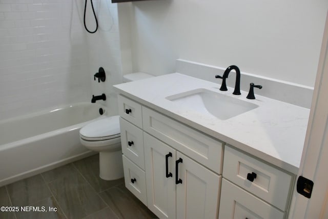 bathroom with vanity, toilet, and shower / washtub combination
