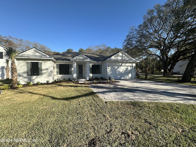 view of front of property with a garage and a front lawn