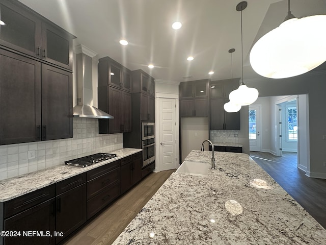 kitchen with sink, wall chimney range hood, stainless steel appliances, and dark wood-type flooring