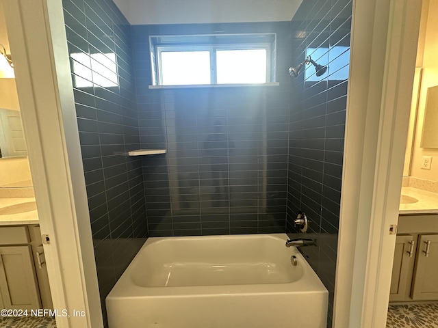 bathroom featuring vanity and tiled shower / bath