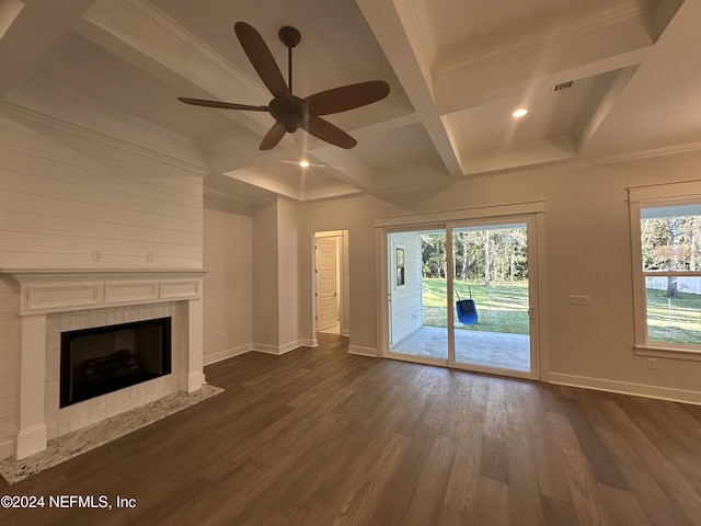 unfurnished living room with a tile fireplace, coffered ceiling, dark hardwood / wood-style floors, ceiling fan, and ornamental molding