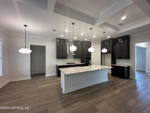 kitchen featuring light stone countertops, tasteful backsplash, dark hardwood / wood-style floors, and a center island with sink