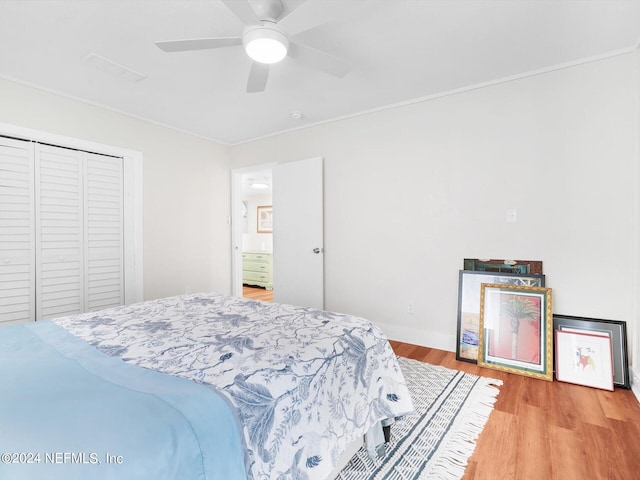 bedroom with a closet, ceiling fan, and hardwood / wood-style flooring