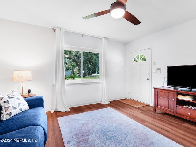 living room featuring hardwood / wood-style flooring and ceiling fan