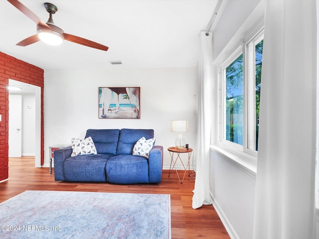 living room featuring ceiling fan, a healthy amount of sunlight, and wood-type flooring