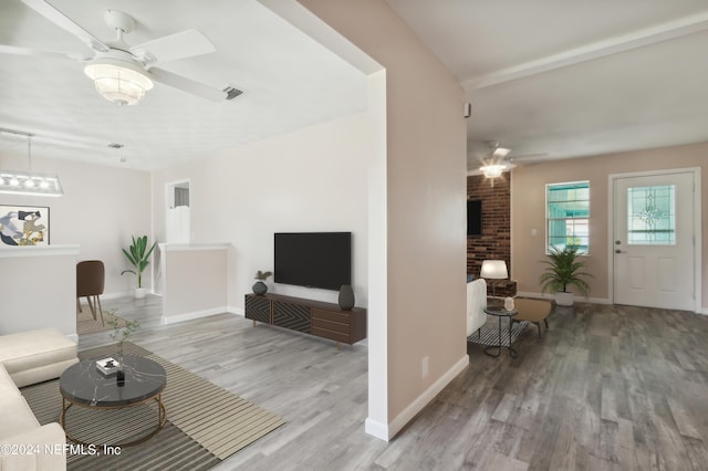 living room featuring hardwood / wood-style floors and ceiling fan