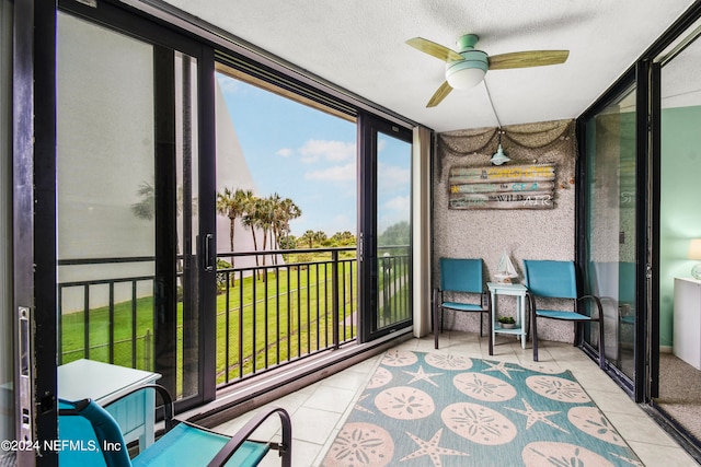 sunroom / solarium featuring ceiling fan