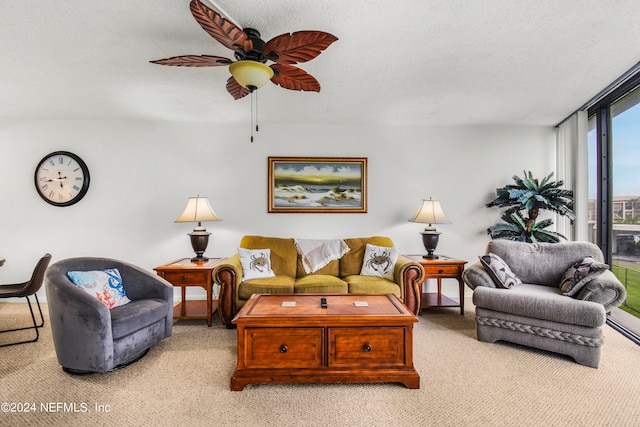 living room with carpet floors, a textured ceiling, and ceiling fan