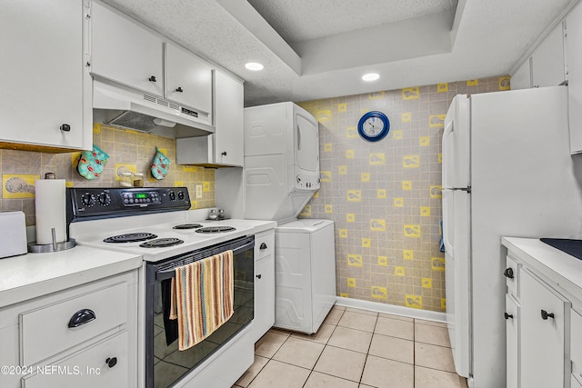 kitchen with white cabinets, white appliances, light tile patterned floors, and a textured ceiling