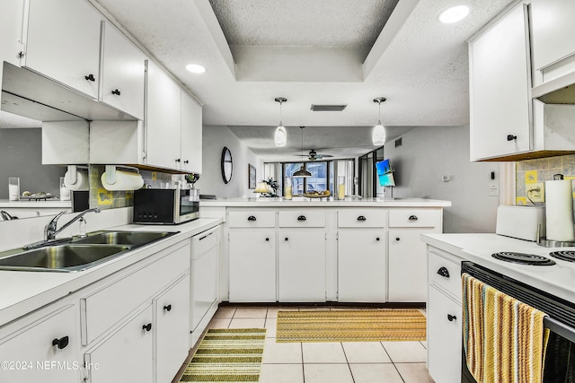 kitchen featuring sink, white cabinetry, and decorative light fixtures