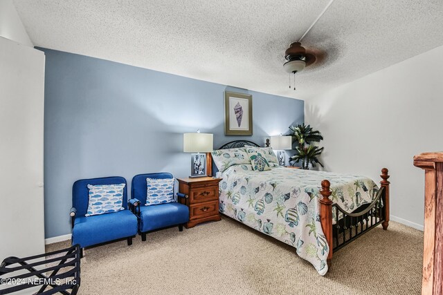 bedroom with a textured ceiling, ceiling fan, and carpet flooring