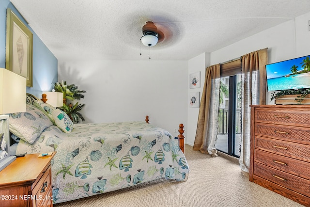 carpeted bedroom with a textured ceiling, access to exterior, and ceiling fan