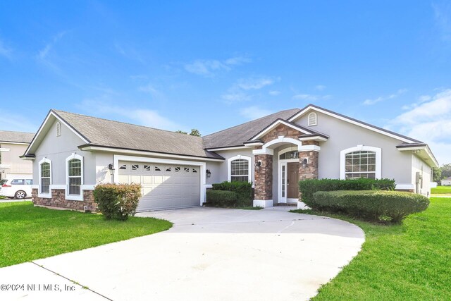 view of front of house featuring a garage and a front yard