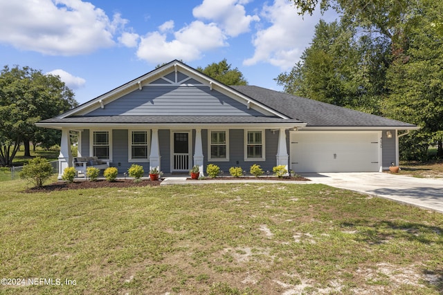 view of front facade featuring a garage, covered porch, and a front lawn