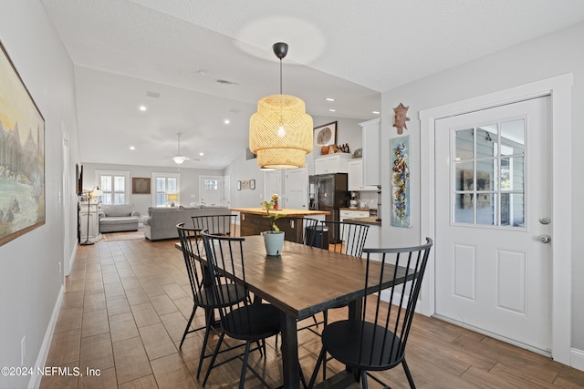 dining space featuring vaulted ceiling