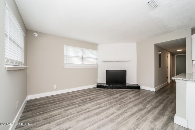 unfurnished living room with hardwood / wood-style flooring