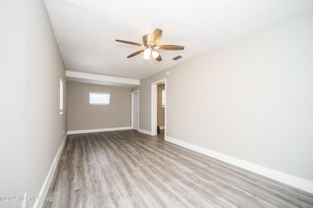 spare room with ceiling fan and light wood-type flooring