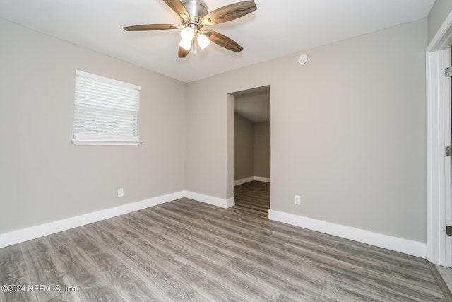 unfurnished room with hardwood / wood-style floors and ceiling fan