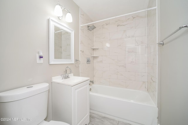 full bathroom with vanity, tiled shower / bath combo, and toilet