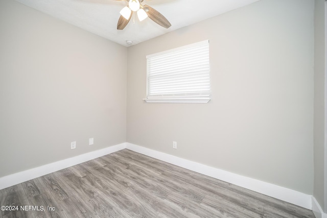 empty room with ceiling fan and light hardwood / wood-style floors