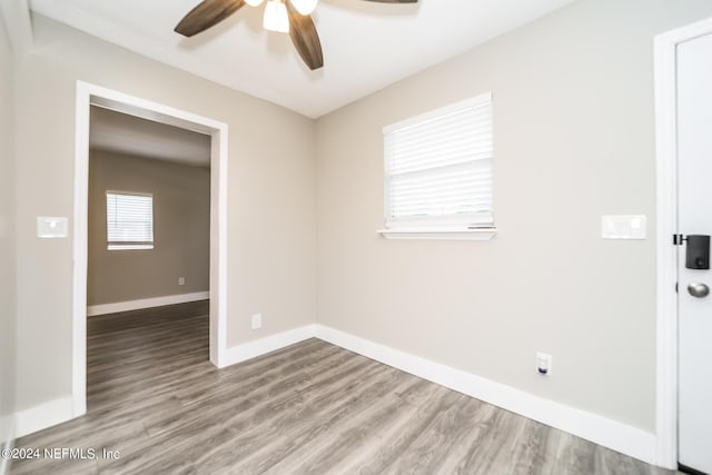 empty room featuring ceiling fan and light hardwood / wood-style floors