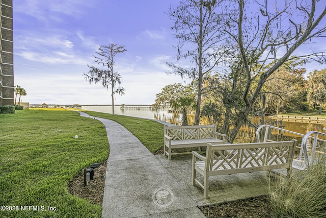 6000 San Jose Blvd Unit 11-C, Jacksonville, FL 32217 - surrounding community featuring a lawn, a water view, and a patio area