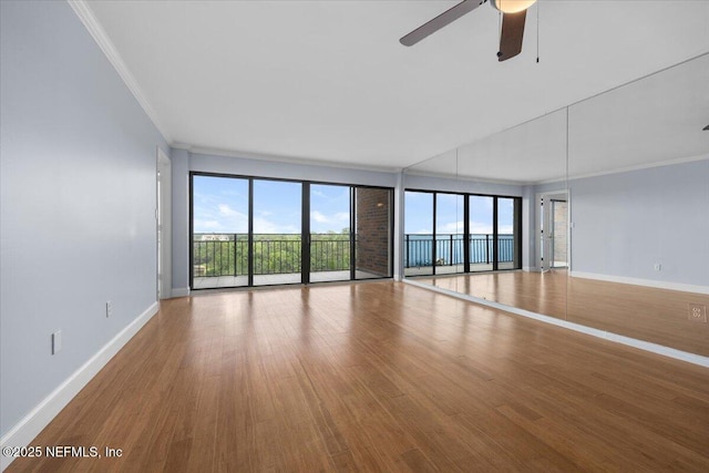 6000 San Jose Blvd Unit 11-C, Jacksonville, FL 32217 - unfurnished room featuring baseboards, ornamental molding, a ceiling fan, and wood finished floors