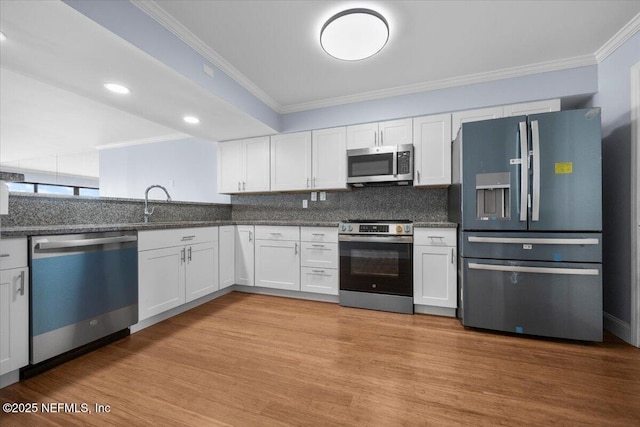 6000 San Jose Blvd Unit 11-C, Jacksonville, FL 32217 - kitchen with crown molding, white cabinetry, and stainless steel appliances