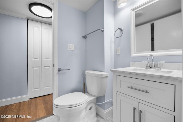 6000 San Jose Blvd Unit 11-C, Jacksonville, FL 32217 - bathroom with baseboards, wood finished floors, toilet, and vanity
