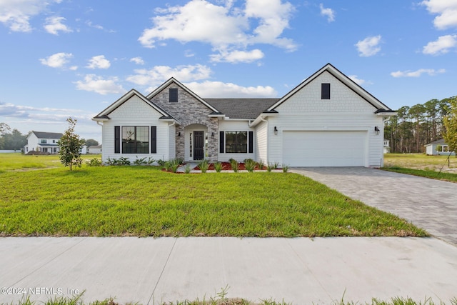 85425 Sandy Ridge Loop Unit 0085, Yulee, FL 32097 - view of front facade featuring a garage, stone siding, decorative driveway, and a front yard
