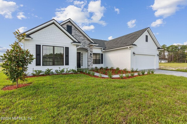 85425 Sandy Ridge Loop Unit 0085, Yulee, FL 32097 - view of front facade featuring a garage, concrete driveway, and a front lawn